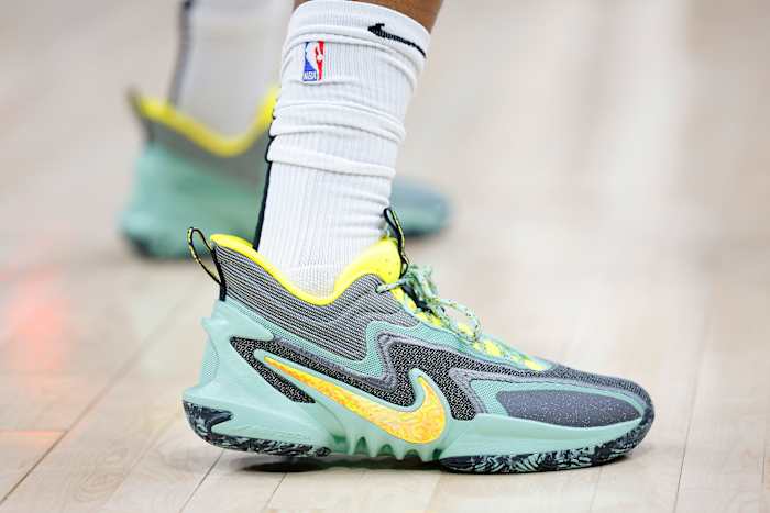 View of green and yellow Nike shoes.